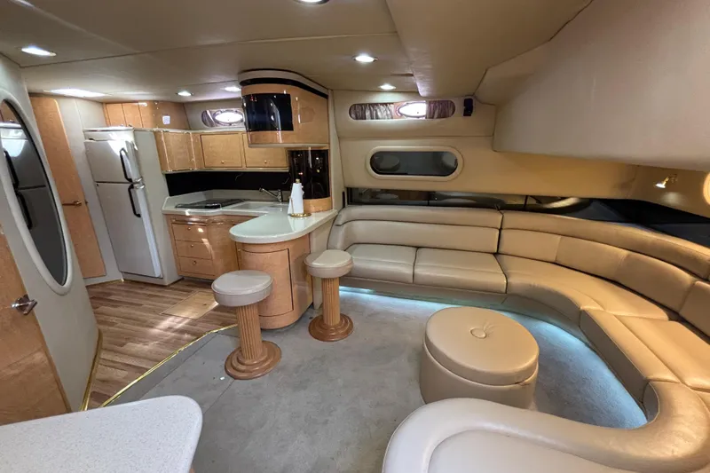 Slide: The Image of Luxurious interior of a 1998 Sea Ray 500 Sundancer yacht with modern kitchen and seating area. - 13