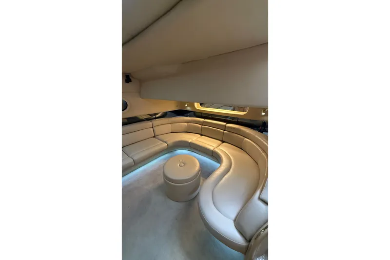 Slide: The Image of Luxurious interior of 1998 Sea Ray 500 Sundancer yacht with curved seating and ambient lighting. - 15
