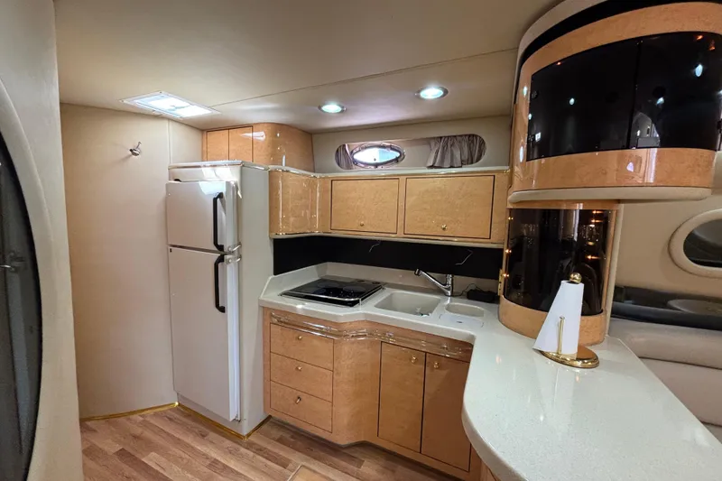 Slide: The Image of Luxurious 1998 Sea Ray 500 Sundancer yacht interior kitchen with modern amenities. - 16