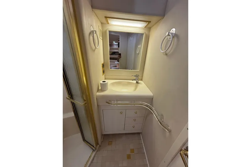 Slide: The Image of Bathroom interior of 1998 Sea Ray 500 Sundancer yacht, featuring sink and mirror. - 23