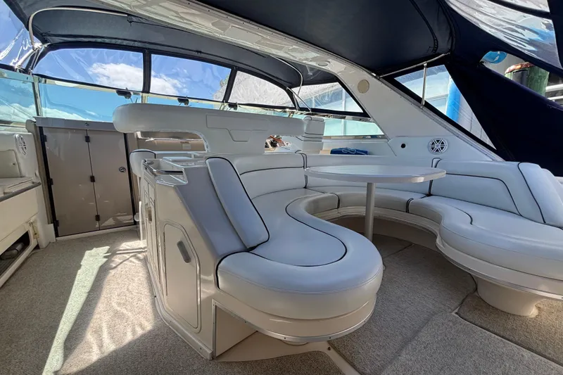 Slide: The Image of Luxurious interior of a 1998 Sea Ray 500 Sundancer yacht with plush seating and table. - 3