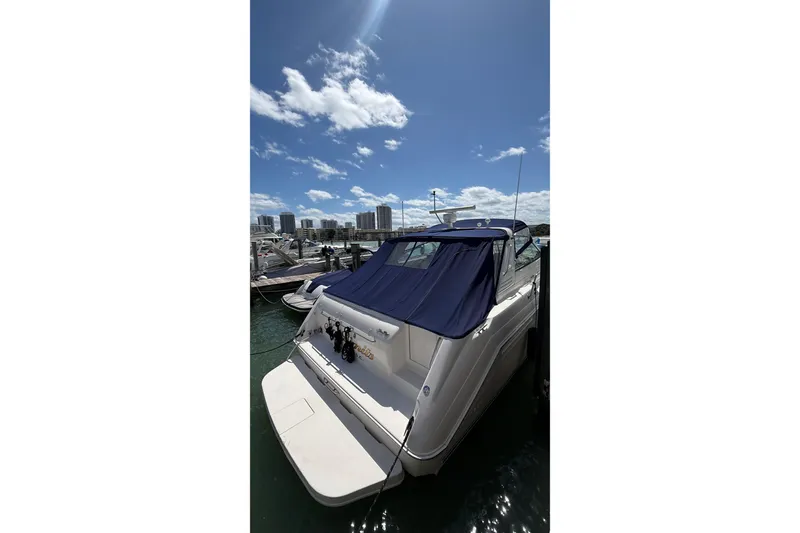 Slide: The Image of 1998 Sea Ray 500 Sundancer yacht docked under a clear blue sky. - 6