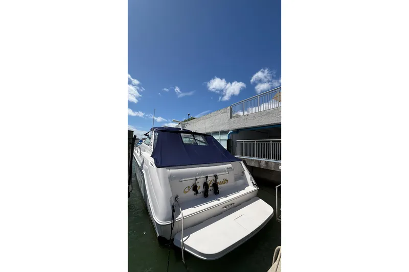 Slide: The Image of 1998 Sea Ray 500 Sundancer yacht docked under clear blue sky. - 7