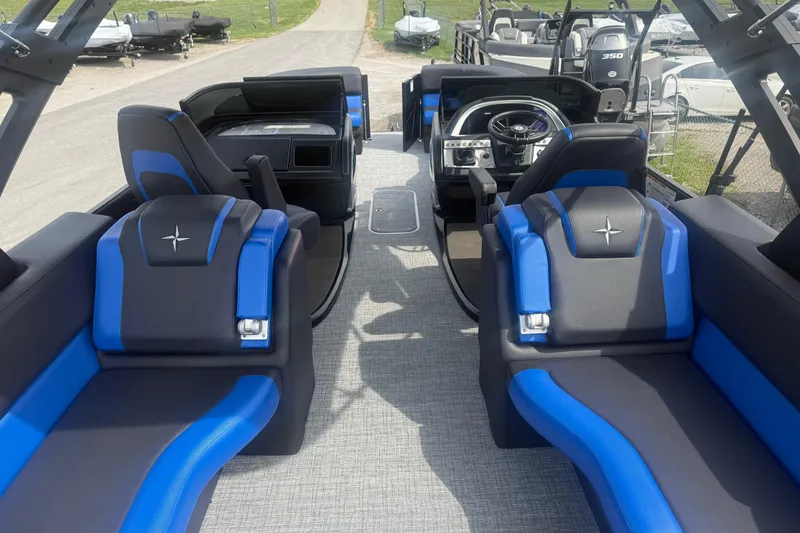 Slide: The Image of 2026 Berkshire 25RFX DC STS boat interior with blue and black seating, modern dashboard. - 10