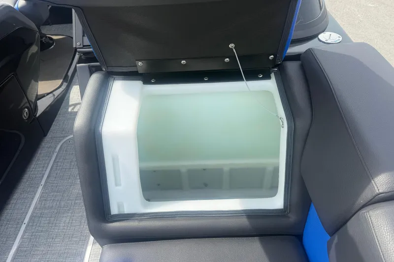Slide: The Image of Open storage compartment in 2026 Berkshire 25RFX DC STS boat, featuring cushioned seating. - 13