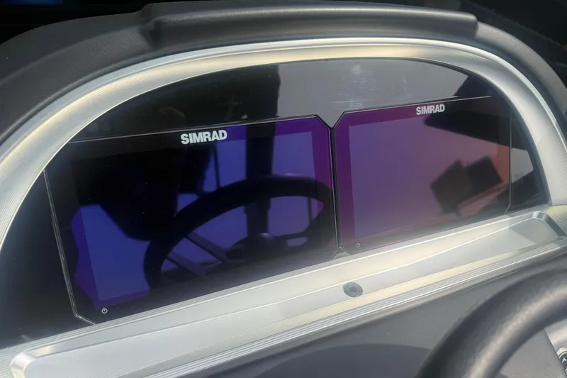 Slide: The Image of Simrad dual displays on 2026 Berkshire 25RFX DC STS dashboard, showcasing modern navigation technology. - 17