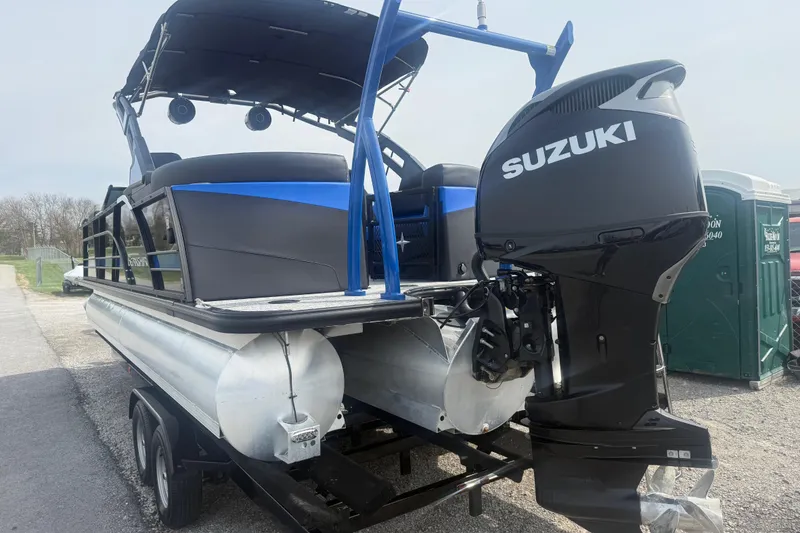 Slide: The Image of 2026 Berkshire 25RFX DC STS pontoon boat with Suzuki outboard motor on trailer. - 4