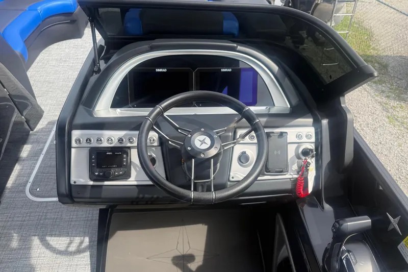 Slide: The Image of 2026 Berkshire 25RFX DC STS boat dashboard with steering wheel and control panel. - 7
