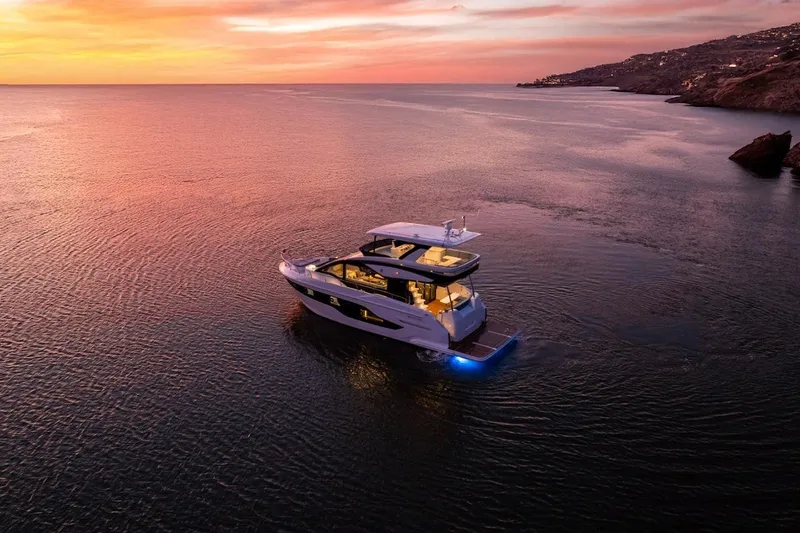 Slide: The Image of 2026 Cruisers Yachts 50 Fly at sunset on tranquil waters. - 14
