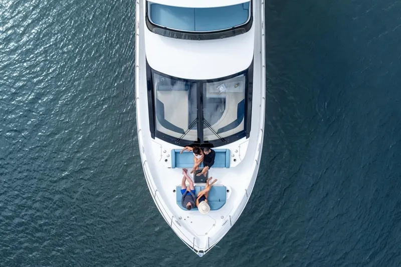 Slide: The Image of Aerial view of 2026 Cruisers Yachts 50 Fly with people relaxing on deck. - 18