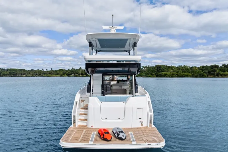 Slide: The Image of 2026 Cruisers Yachts 50 Fly on serene water, showcasing luxury design and spacious deck. - 19