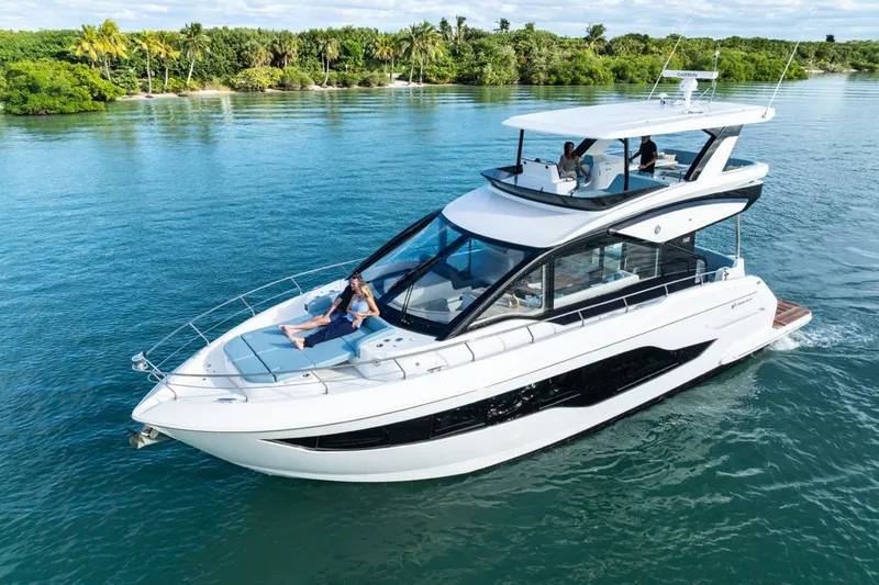 Slide: The Image of 2026 Cruisers Yachts 50 Fly luxury yacht cruising on serene blue waters. - 25