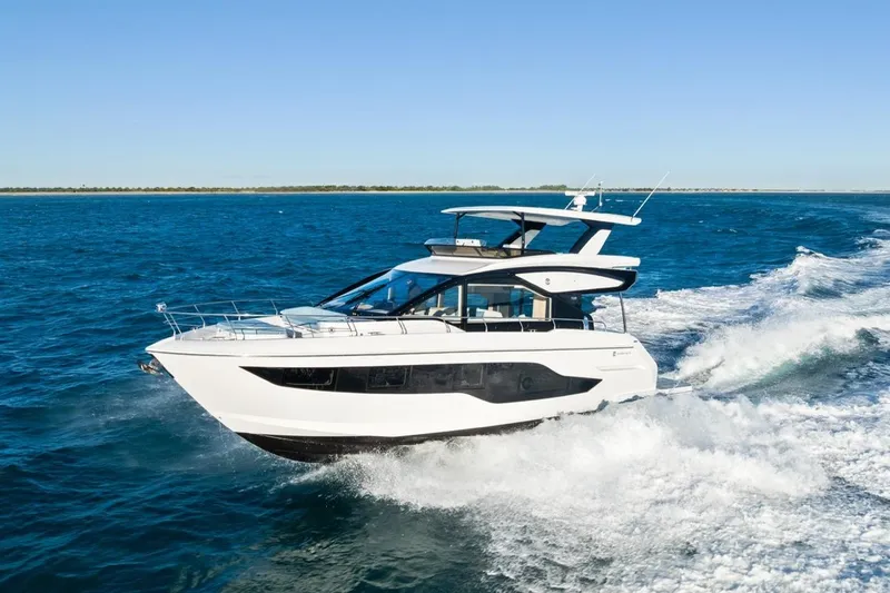 Slide: The Image of 2026 Cruisers Yachts 50 Fly cruising on open water, showcasing sleek design and luxury. - 36