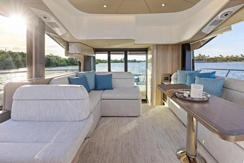 Slide: The Image of Luxurious interior of 2026 Cruisers Yachts 50 Fly with elegant seating and scenic water view. - 49
