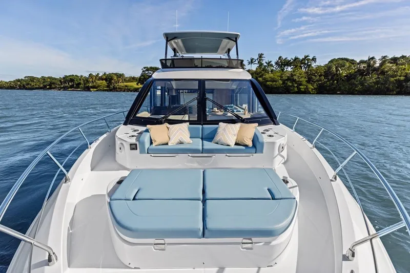 Slide: The Image of Luxurious 2026 Cruisers Yachts 50 Fly on serene water, featuring spacious deck seating. - 52