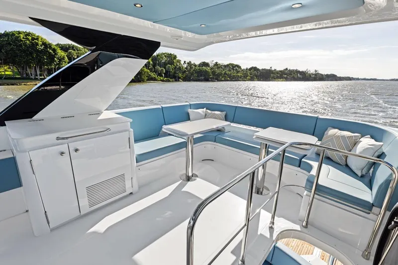 Slide: The Image of Luxurious 2026 Cruisers Yachts 50 Fly with elegant seating and scenic water view. - 58