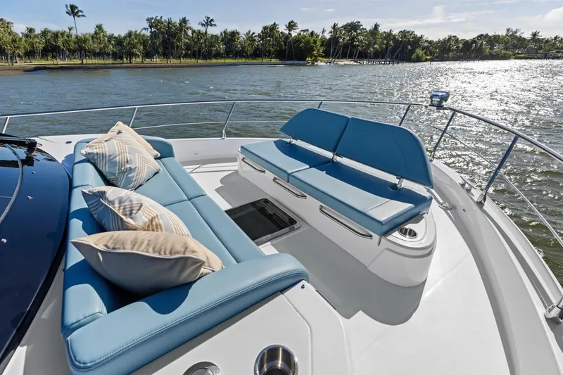 Slide: The Image of Luxurious seating area on 2026 Cruisers Yachts 50 Fly, overlooking serene waters. - 66