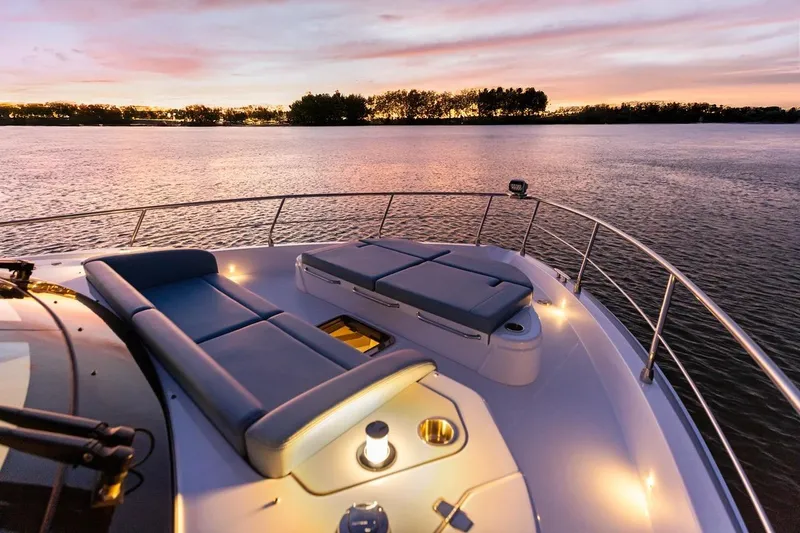 Slide: The Image of Luxurious 2026 Cruisers Yachts 50 Fly at sunset, featuring elegant deck seating. - 79