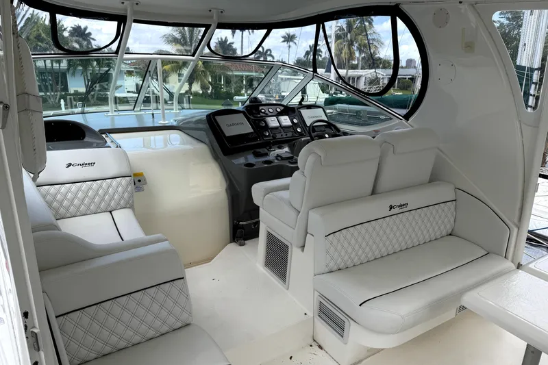 Slide: The Image of 2005 Cruisers Yachts 405 Express Motoryacht interior with luxurious seating and modern dashboard. - 11