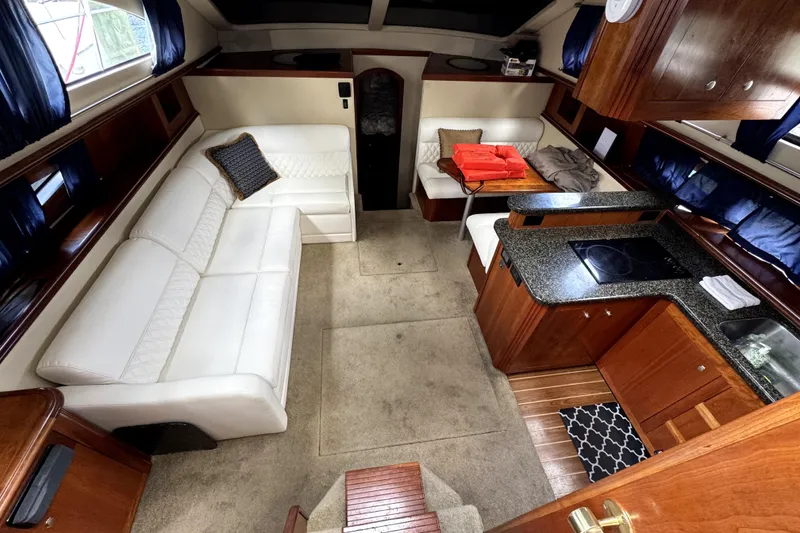 Slide: The Image of Luxurious interior of 2005 Cruisers Yachts 405 Express Motoryacht with white seating and modern kitchen. - 12
