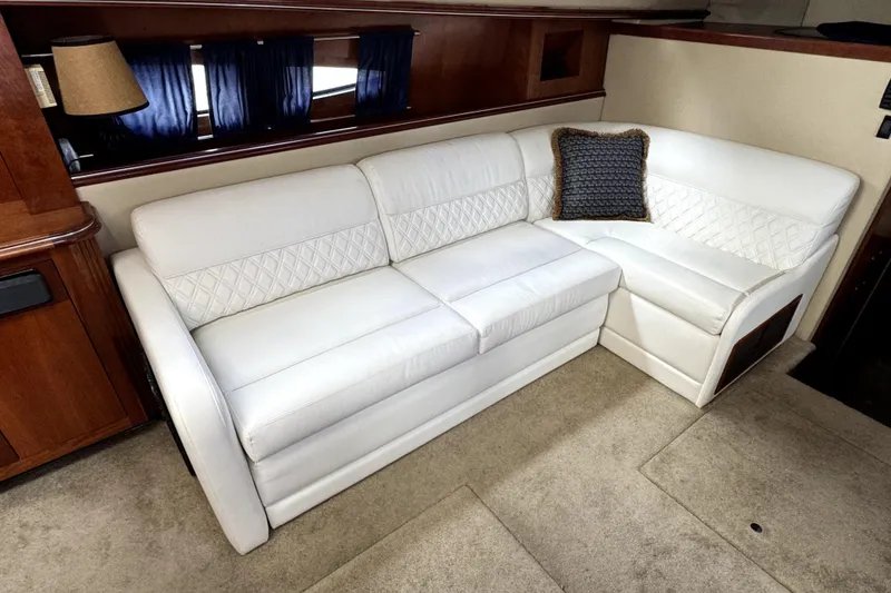 Slide: The Image of Luxurious white leather sofa in 2005 Cruisers Yachts 405 Express Motoryacht interior. - 14
