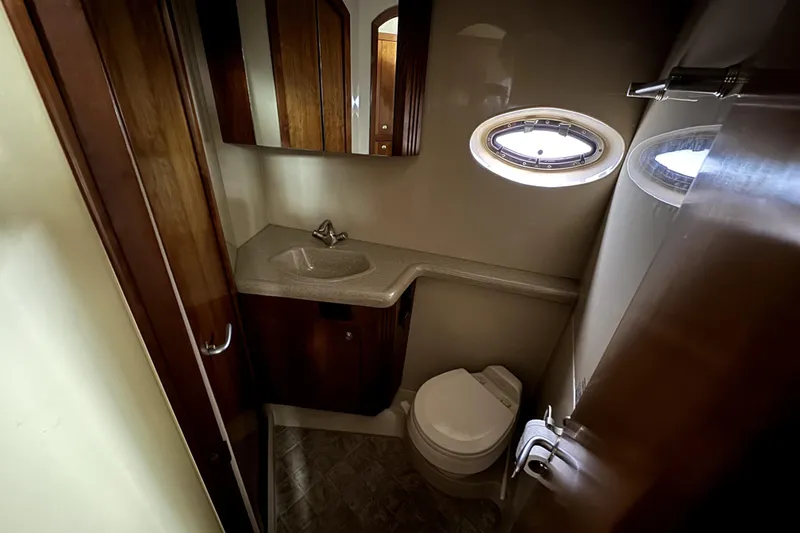 Slide: The Image of Luxurious bathroom in 2005 Cruisers Yachts 405 Express Motoryacht with sink and porthole window. - 16