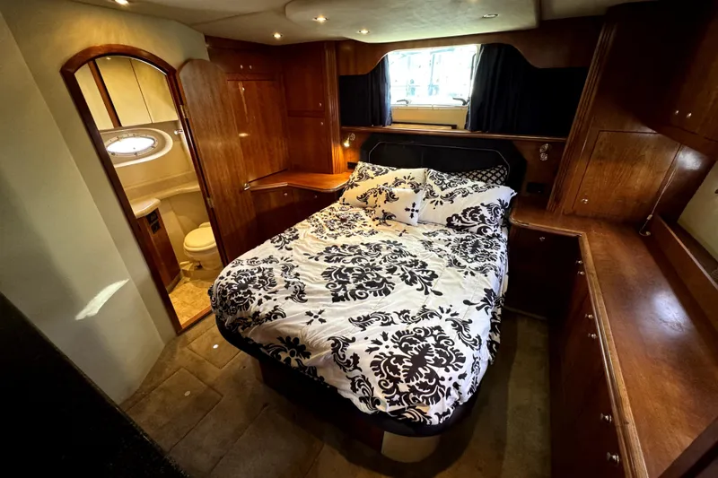 Slide: The Image of Luxurious bedroom in 2005 Cruisers Yachts 405 Express Motoryacht with elegant wood cabinetry. - 18