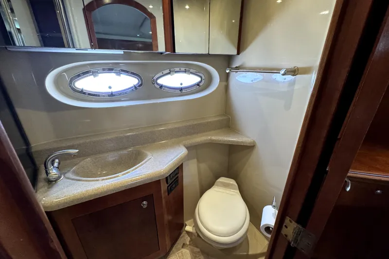 Slide: The Image of Luxurious bathroom in 2005 Cruisers Yachts 405 Express Motoryacht with oval windows and modern fixtures. - 21