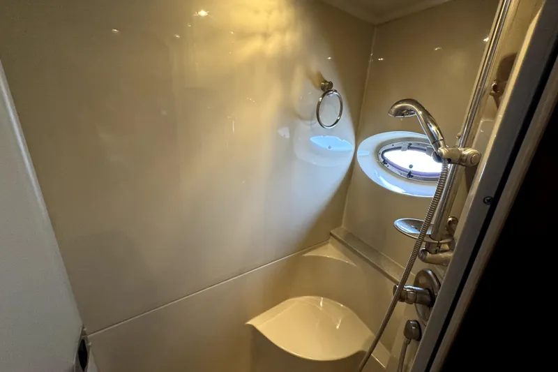 Slide: The Image of Bathroom interior of 2005 Cruisers Yachts 405 Express Motoryacht with shower and porthole window. - 25