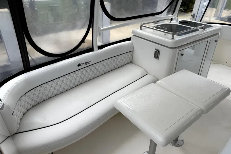 Slide: The Image of 2005 Cruisers Yachts 405 Express Motoryacht interior with white seating and table. - 5