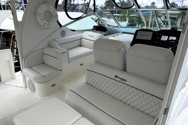 Slide: The Image of 2005 Cruisers Yachts 405 Express Motoryacht interior with plush seating and modern navigation equipment. - 6