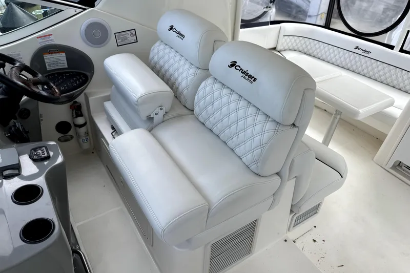 Slide: The Image of 2005 Cruisers Yachts 405 Express Motoryacht helm with luxurious white seating. - 9