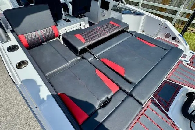 Slide: The Image of 2026 Monterey Elite 25 OB boat interior with black and red seating, showcasing luxury design. - 10