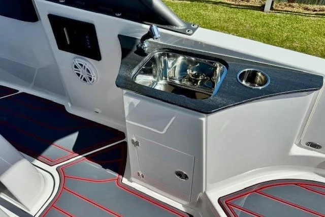 Slide: The Image of 2026 Monterey Elite 25 OB boat interior with sink and modern design. - 11