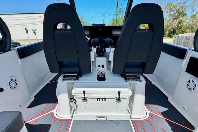 Slide: The Image of 2026 Monterey Elite 25 OB boat interior with dual seats and Yeti cooler. - 12