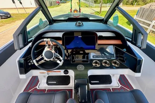 Slide: The Image of Cockpit of 2026 Monterey Elite 25 OB boat with modern steering and digital display. - 15