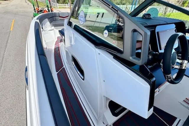 Slide: The Image of 2026 Monterey Elite 25 OB boat interior with sleek design and modern dashboard. - 16
