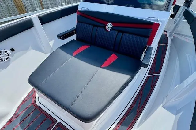 Slide: The Image of 2026 Monterey Elite 25 OB boat interior with stylish black and red seating. - 19