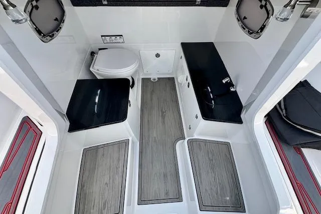 Slide: The Image of Interior of 2026 Monterey Elite 25 OB boat, featuring modern bathroom amenities and sleek design. - 20