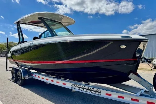 Slide: The Image of 2026 Monterey Elite 25 OB boat on trailer under blue sky. - 5
