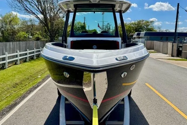 Slide: The Image of 2026 Monterey Elite 25 OB boat on trailer, parked on a sunny road. - 6