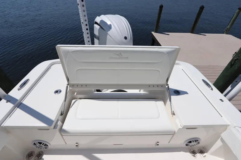 Slide: The Image of 2021 Regulator 24XO boat with white seating and Yamaha engine at dock. - 12