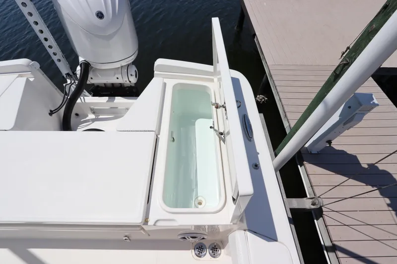 Slide: The Image of 2021 Regulator 24XO boat with open storage compartment at dockside. - 13