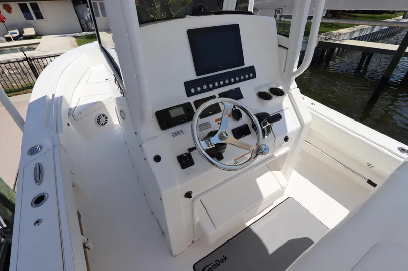 Slide: The Image of 2021 Regulator 24XO boat cockpit with steering wheel and control panel. - 18