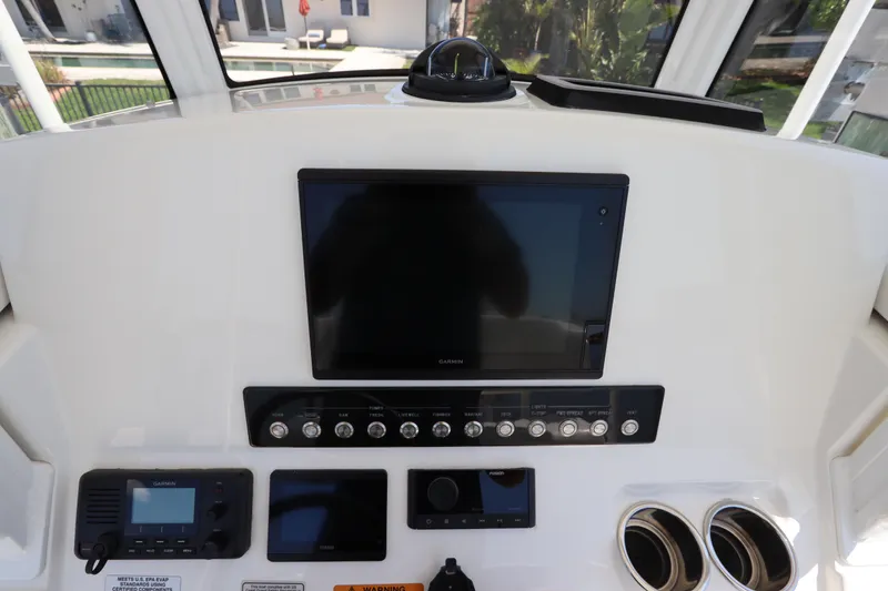 Slide: The Image of 2021 Regulator 24XO boat dashboard with Garmin display and control panel. - 19