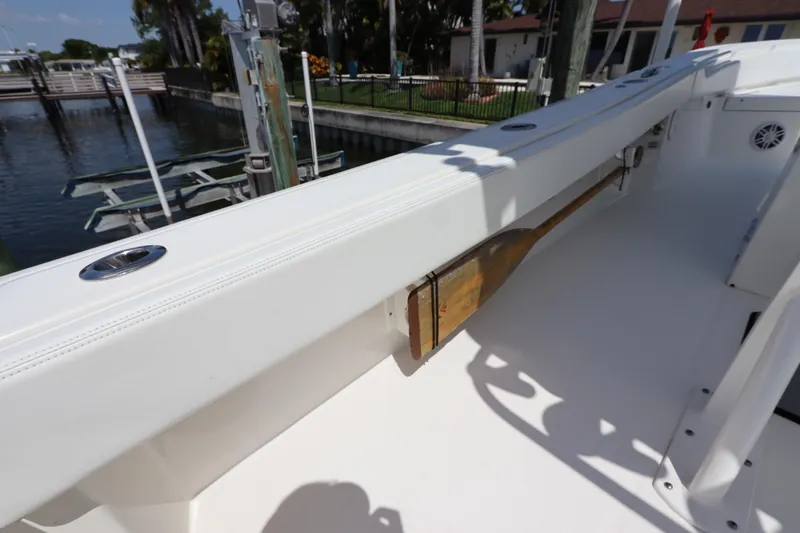 Slide: The Image of 2021 Regulator 24XO boat interior with paddle storage, dockside view. - 24