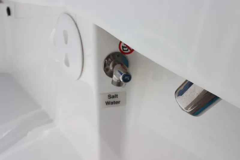 Slide: The Image of Saltwater outlet on 2021 Regulator 24XO boat, featuring sleek white design. - 27