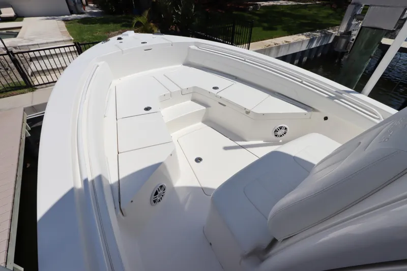Slide: The Image of 2021 Regulator 24XO boat with spacious white seating and storage compartments. - 28