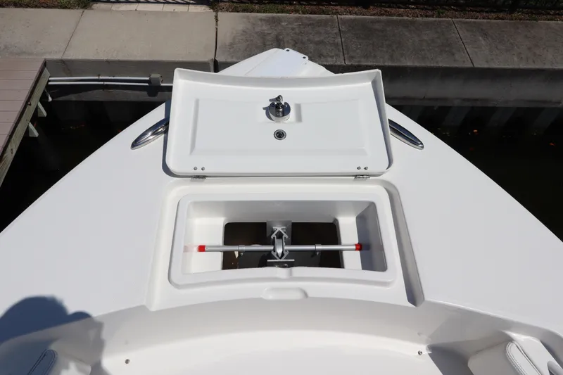 Slide: The Image of 2021 Regulator 24XO boat anchor locker with open hatch, dockside view. - 29