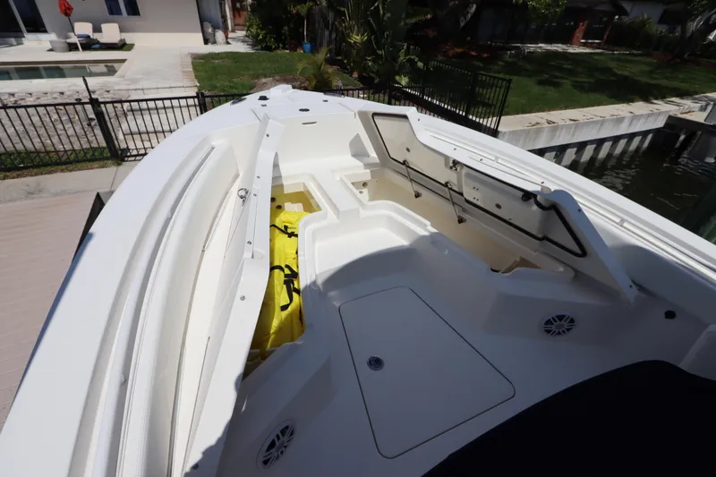 Slide: The Image of 2021 Regulator 24XO boat interior with open storage compartments and seating area. - 30